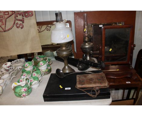Two oil lamps; a Banbo camera tripod; a silver plated ladle; a vintage leather bag and a Backgammon set 