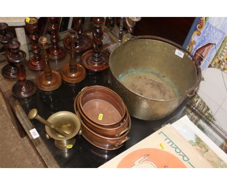 A graduated set of three copper pans, a brass pestle and mortar, and a preserve pan 