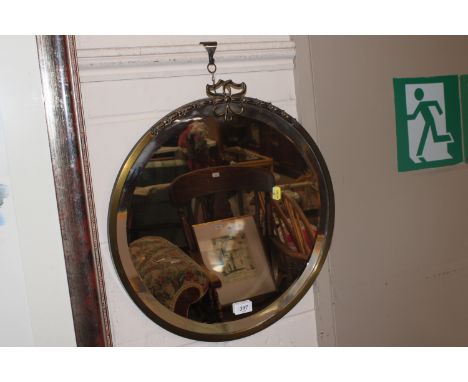 A brass framed circular bevel edged wall mirror 