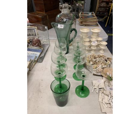 A GREEN LEMONADE JUG WITH GLASS SWIZZLE STICK, NINE WINE GLASSES AND A DEMI-JOHN 