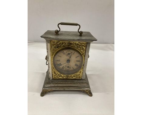 AN OFFICER'S ALARM CLOCK WITH BRASS DECORATION AND LION HEADS TO THE SIDE 