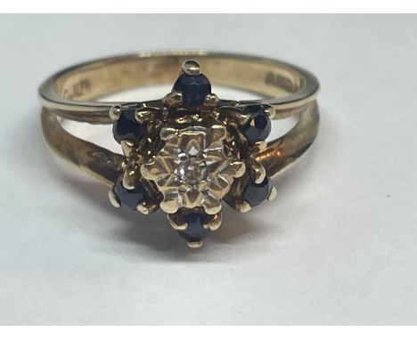 A 9 CARAT GOLD RING WITH A CLUSTER OF DIAMONDS AND SAPPHIRES SIZE K/L 