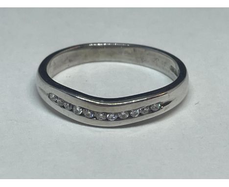 A 9 CARAT WHITE GOLD RING WITH A LINE OF DIAMONDS IN A WISHBONE DESIGN SIZE K 