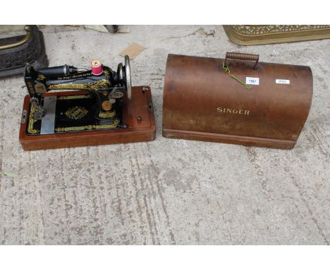 A VINTAGE SINGER SEWING MACHINE WITH WOODEN CARRY CASE 