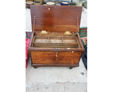 A VINTAGE WOODEN TOOL CHEST WITH FOUR WHEELS TO THE BASE 