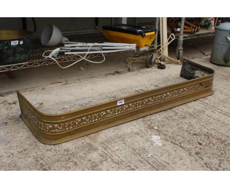 A VINTAGE AND DECORATIVE PIERCED BRASS FIRE FENDER 