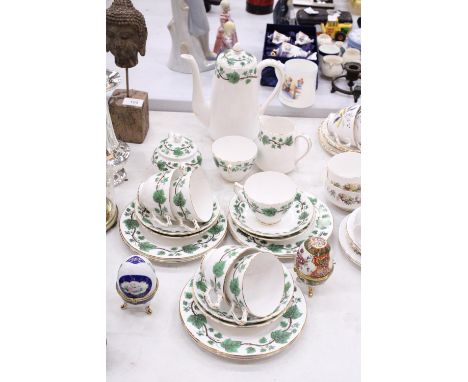 A "CROWN STAFFORDSHIRE" - GREEN IVY TEASET SET TO INCLUDE CUPS, SAUCERS, JUG AND SUGAR BOWL WITH A FURTHER TWO CERAMIC EGG TR