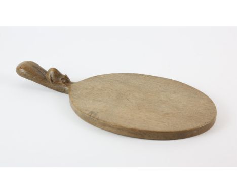 ROBERT 'MOUSEMAN' THOMPSON (BRITISH, 1876-1955), an oak cheese board, 38cm long x 18.5cm wide 