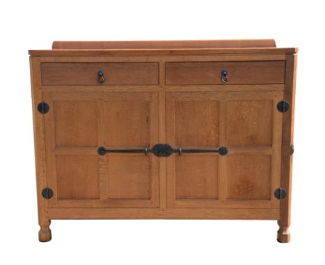 WORKSHOP OF ROBERT 'MOUSEMAN' THOMPSON (BRITISH, 1876-1955), an oak sideboard, with canted corners, the rectangular top with 