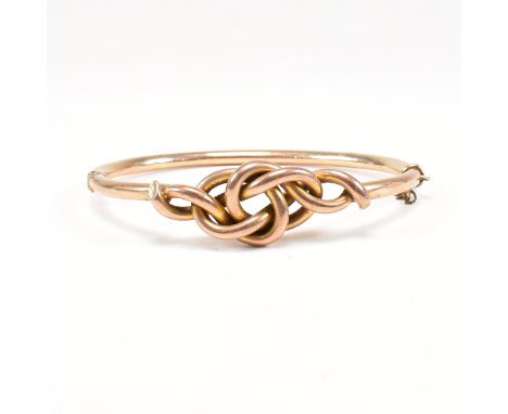 An early 20th century knot bangle. The antique bangle having a large knot head to hinged tube bangle with concealed clasp. Ma