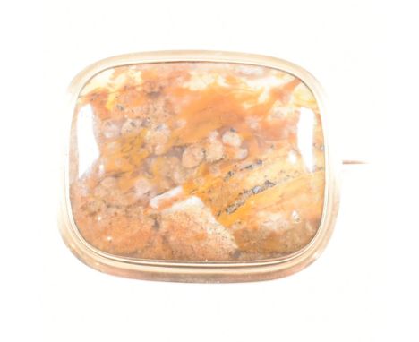 An antique agate and yellow metal brooch pin. The brooch having a bezel set rounded rectangular cabochons of mottled brown ag