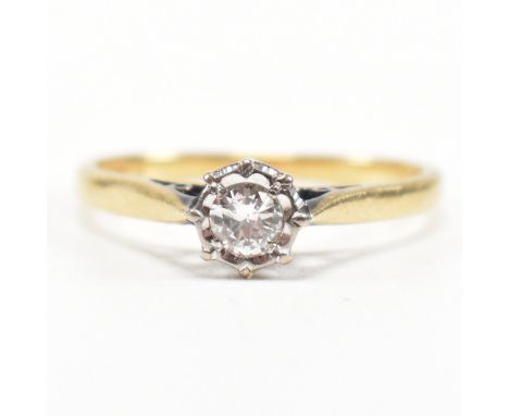 A hallmarked 18ct gold and diamond solitaire ring. The ring having an illusion set round brilliant cut diamond to cathedral s