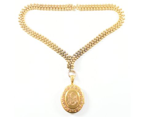 A 19th century Victorian gold locket pendant necklace. The locket having a central monogrammed plaque framed by repousse hear