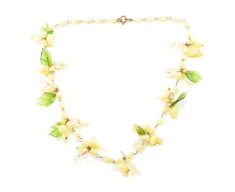 A vintage Murano glass bead necklace. The necklace comprised of yellow bird shaped beads accompanied by green leaf beads and 
