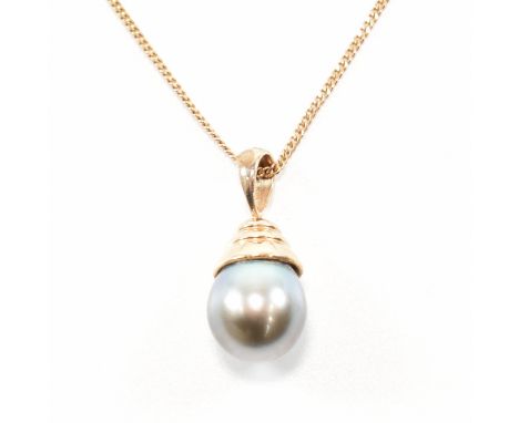A gold and Tahitian pearl pendant necklace. The necklace strung with a single Tahitian pearl surmounted by a terraced mount s