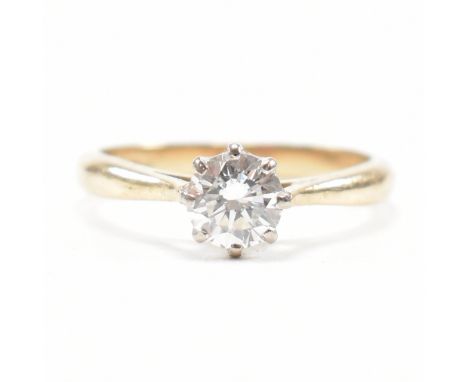 A hallmarked 18ct gold and diamond solitaire ring. The ring set with a single round brilliant cut diamond to cathedral should