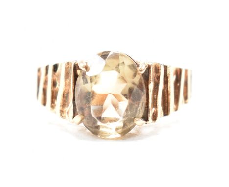 A vintage hallmarked 9ct yellow gold and smoky quartz solitaire ring. The single stone ring having an oval cut claw set smoky