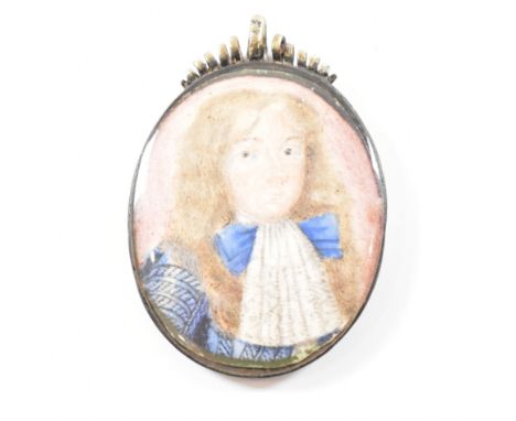 An early miniature locket pendant. The pendant locket containing an early naive portrait of a boy on vellum. The locket havin