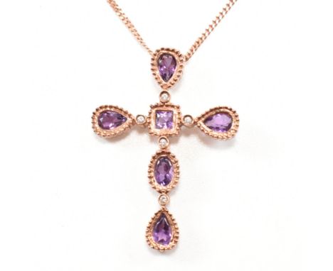 A hallmarked 9ct Clogau rose gold, amethyst and diamond pendant necklace. The pendant in the form of a Christian cross set wi