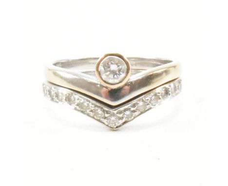 A 9ct white gold and diamond stacking ring set. The set consisting of a diamond set solitaire ring in wishbone form having a 