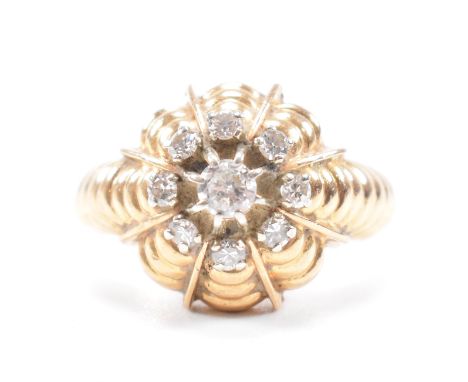 A vintage French and diamond cluster ring. The ring being set with a round cut diamond to the centre with a halo of diamonds 
