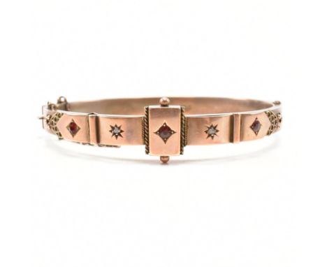 A Victorian hallmarked 9ct rose gold, gem&nbsp;and diamond bangle bracelet. The hinged bangle of oval form having a rectangul