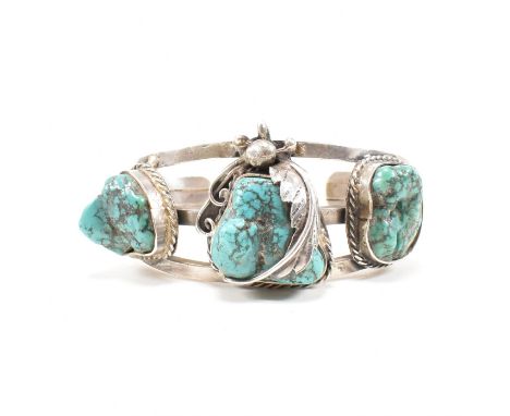 A vintage Navajo native 925 silver and turquoise bangle bracelet. The cuff bangle formed of three bands splayed at the head t