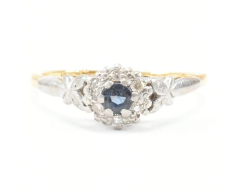 A 1920s 18ct gold and platinum sapphire and diamond halo ring. The ring set with a central topaz framed by illusion set diamo