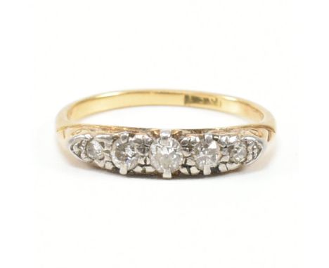 A vintage 18ct gold and diamond five stone ring. The ring being set with five graduating diamonds within a scrolled mount to 