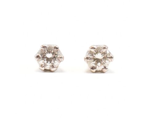 A pair of 18ct gold and diamond stud earrings. The earrings set with 2 round brilliant cut diamonds. Estimated total diamond 