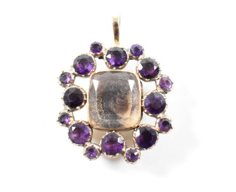 A 19th century Georgian gold amethyst locket memento mori pendant. The pendant having a central locket compartment enclosing 
