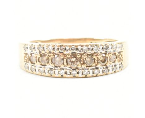 A hallmarked 9ct gold and diamond half hoop ring. The ring set with a central row of champagne diamonds framed by two rows of