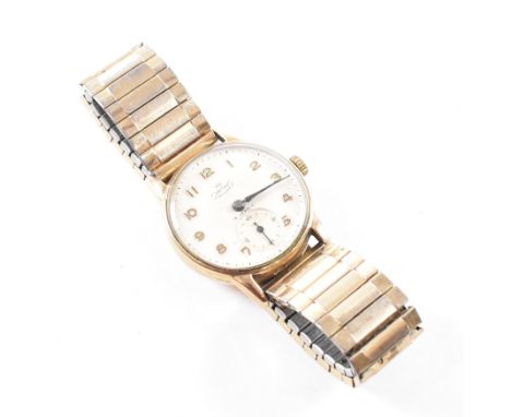 A hallmarked 9ct yellow gold cased Smith De Luxe Dennison wristwatch. The watch having a circular white dial with gold tone A
