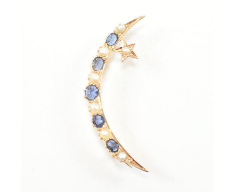 An antique sapphire and pearl crescent brooch pin. The brooch of yellow metal in the form of a crescent moon and star set wit