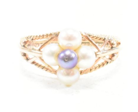 A gold and pearl cluster ring. The ring set with a central cluster of cultured pearls to a pierced dome mount with filigree d