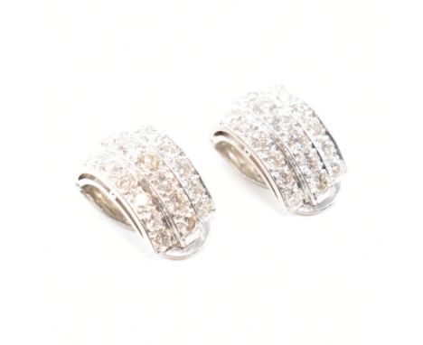 A pair of Art Deco 18ct white gold and diamond ear clips. The earrings set with 21 round brilliant cut diamonds to each. Set 