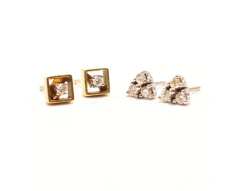 Two pairs of vintage gold and diamond stud earrings. The first pair of 18ct white gold with three round cut diamonds set to t