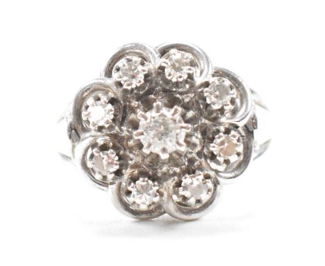 A vintage French 18ct white gold and diamond ring. The ring being set with a central round brilliant cut diamond to the centr