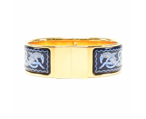 A vintage Hermes enamel clic clac bracelet bangle. The hinged bangle having two enamelled panels to depict stylised horses kn