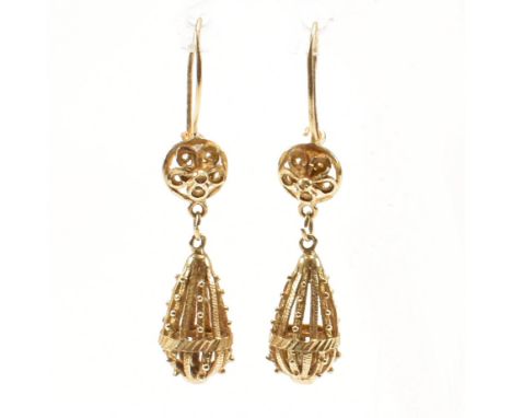 A pair of vintage 14ct yellow gold pendant drop earrings. The antique style hook back earrings each having a pierced floral h