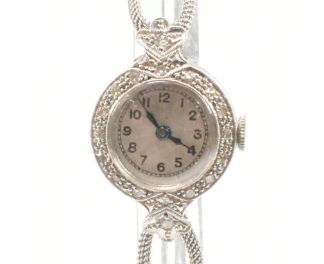 A vintage mid 20th Century Art Deco style diamond, gold and platinum wrist watch. The watch having a round face with Arabic n