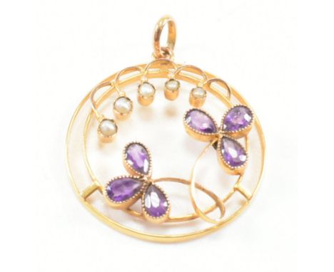 An antique 9ct yellow gold, amethyst and seed pearl necklace pendant. The pendant of circular form having open wire work desi