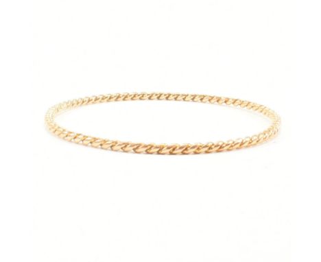 A yellow metal twisted bangle bracelet. The bracelet of circular form with twisted body. Unmarked, surface tests indicate 18c