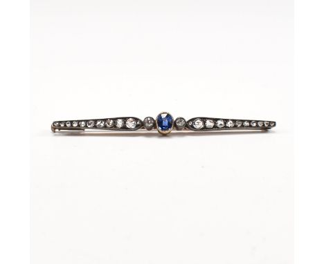 An early 20th century sapphire and diamond bar brooch pin. The antique brooch set with an oval cut sapphire framed by two old