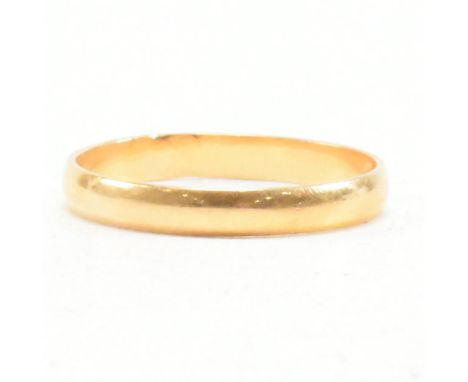 A Middle Eastern gold band ring. The ring in D form bearing Arabic assay Marks. Tests indicate 15ct gold. Weight 1.6g. Size M
