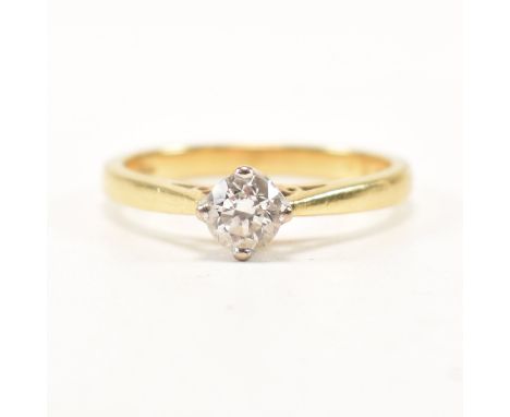 A hallmarked 9ct yellow gold and diamond solitaire ring. The single stone engagement style ring having a round cut compass pr