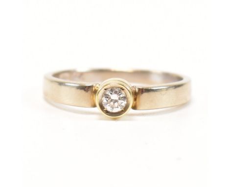 A vintage 14ct bi colour gold and diamond solitaire ring. The two tone single stone engagement style ring having a bezel set 