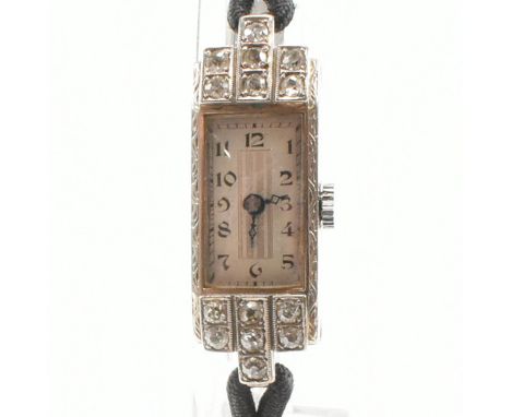 An Art Deco 9ct white gold and diamond Hantily cocktail wristwatch. The watch having a rectangular white dial with striped si