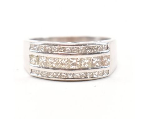 An 18ct white gold and diamond cluster ring. The ring having three rows of graduated square cut diamonds to a tapering shank.