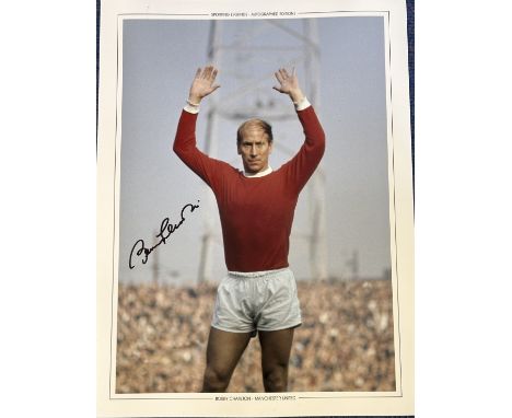 Football Bobby Charlton signed 16x12 Sporting Legends colour print pictured in action for Manchester United. Good condition. 